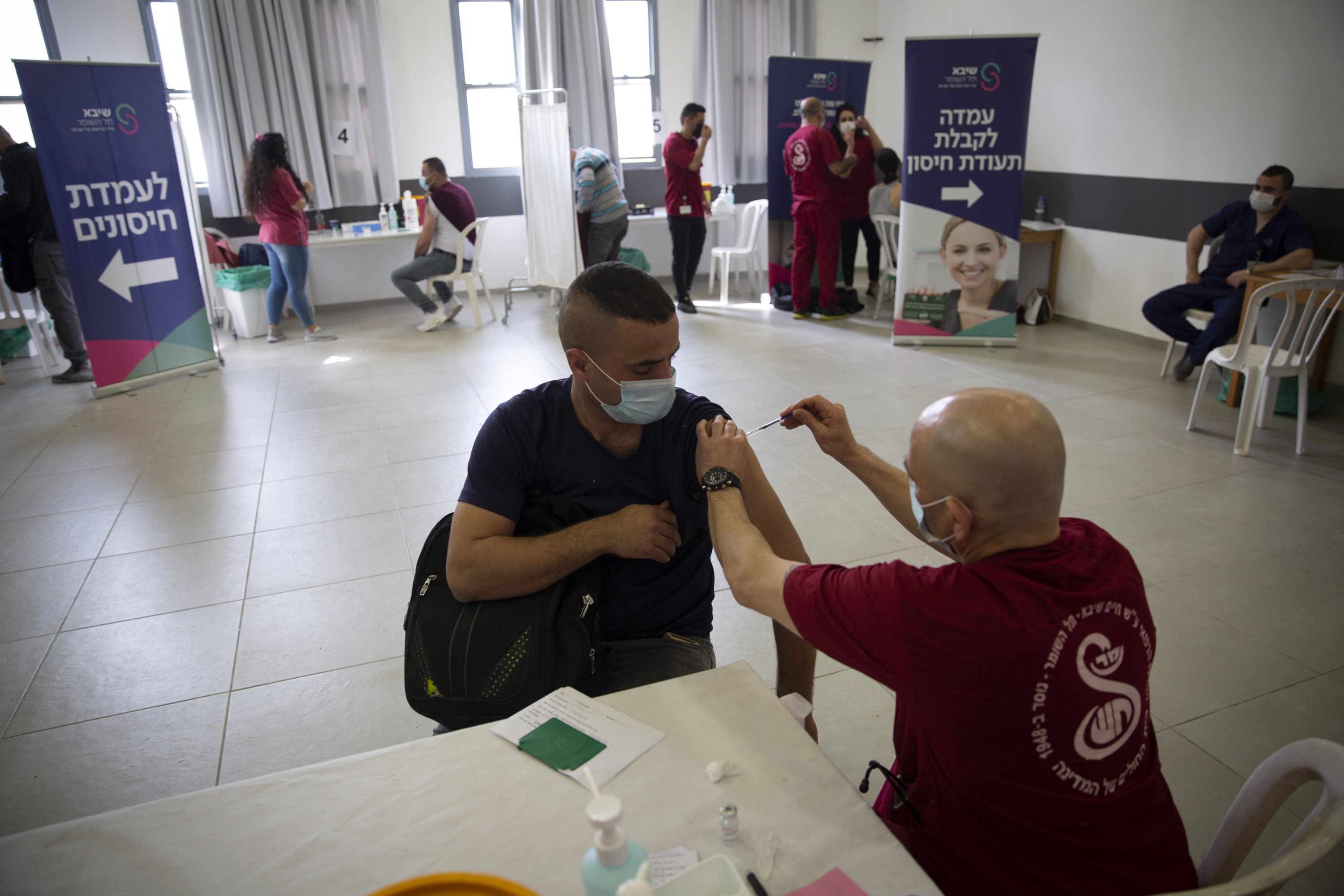 Israel begins vaccinating Palestinian workers against Covid-19 after delays & international condemnation